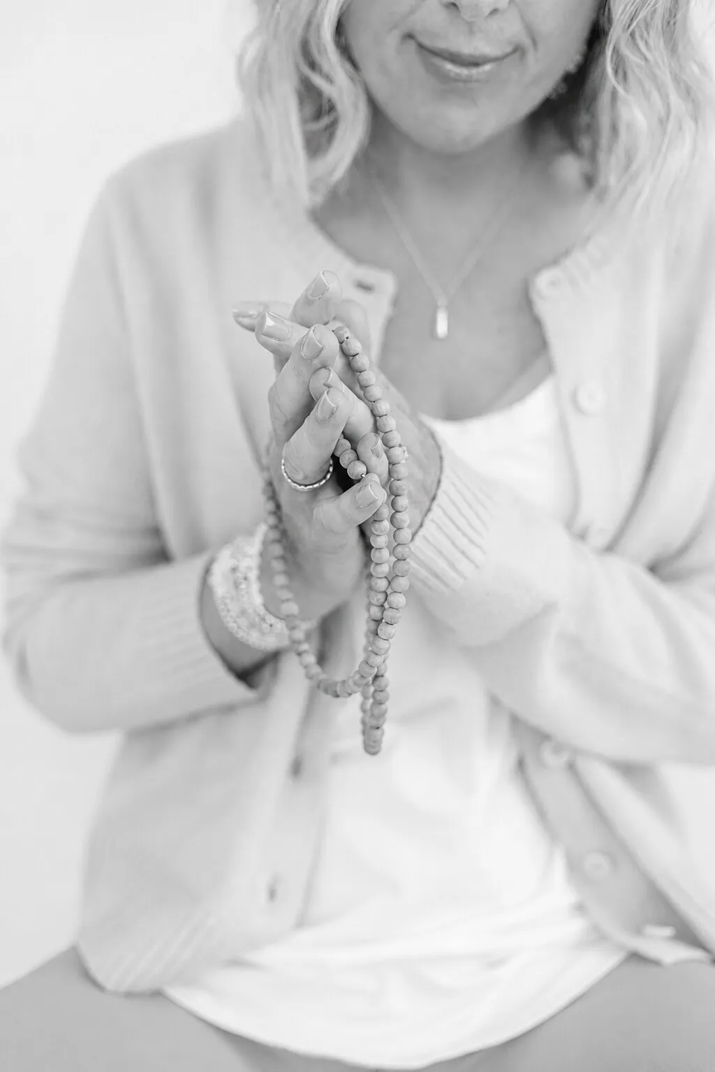 Georgie's hands, holding a string of prayer beads