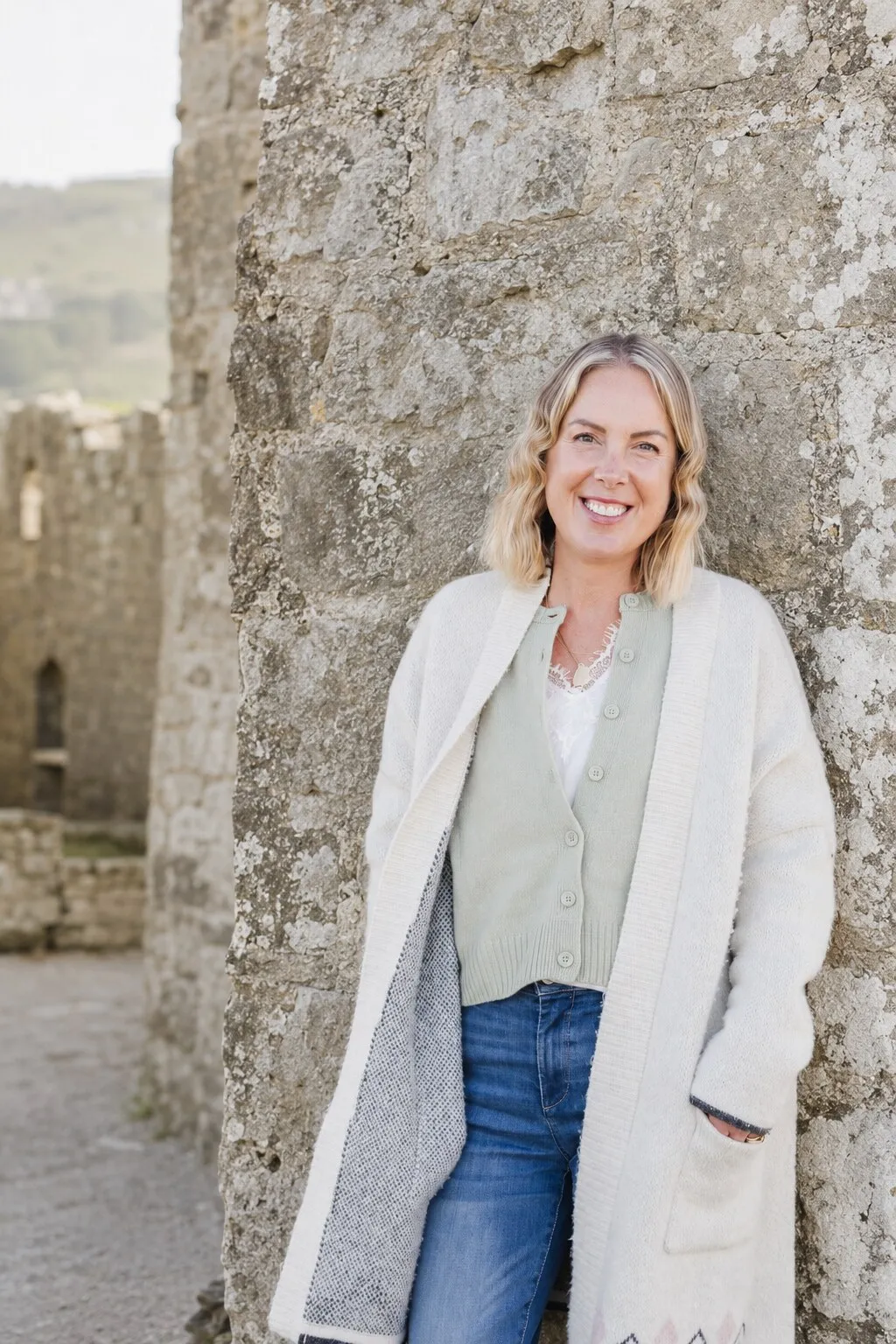 Georgie Durcan outside a stone building on the Irish coast