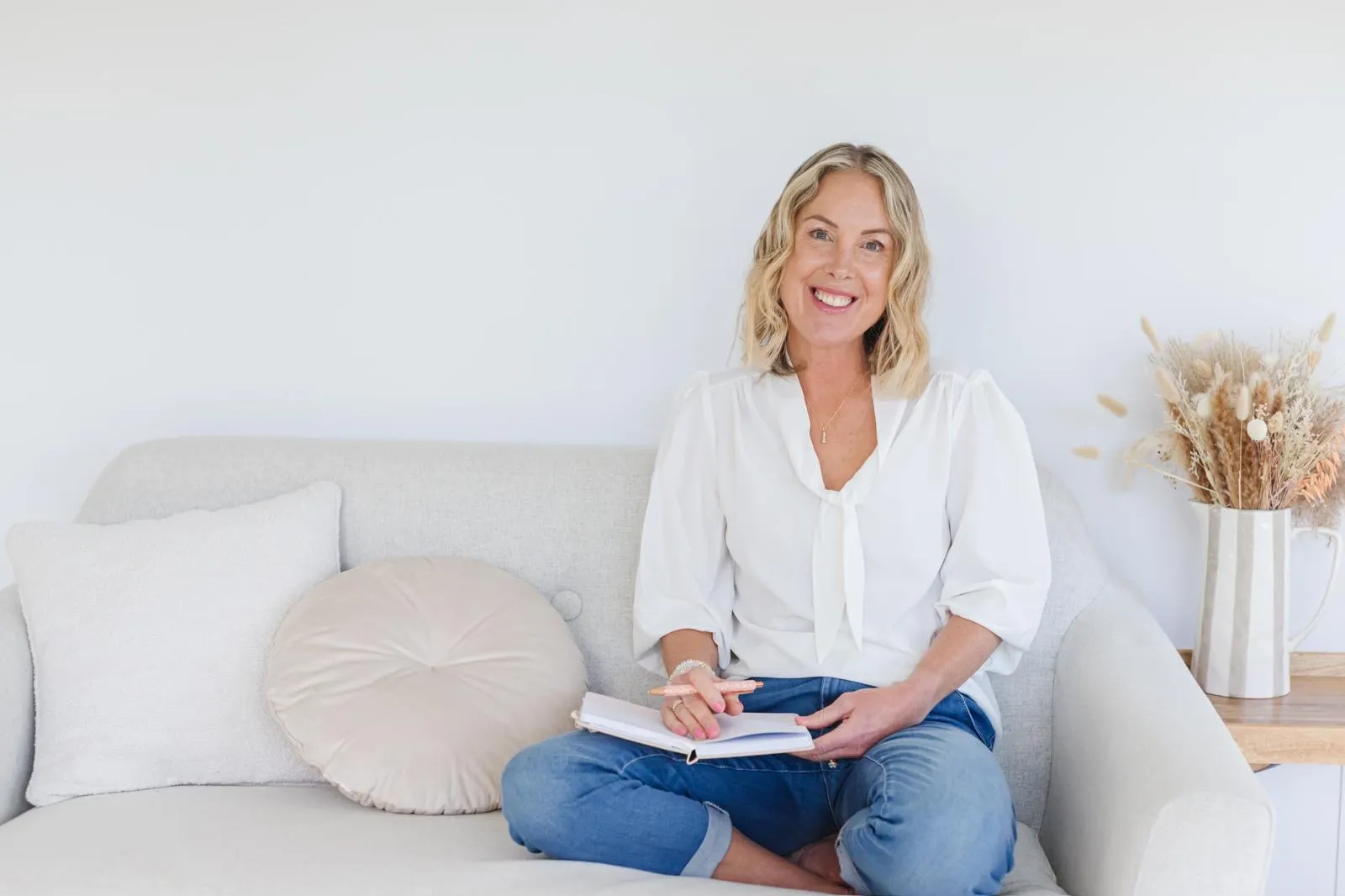 Georgie Durcan sitting on a sofa with an open notebook