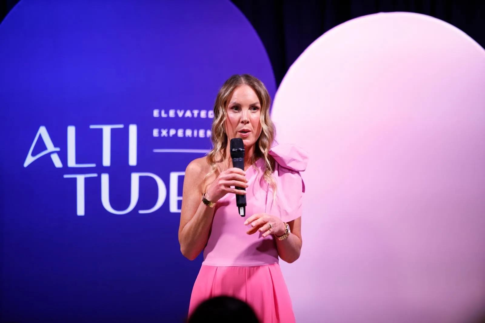 Georgie Durcan speaking on stage at an Elevated Experiences event